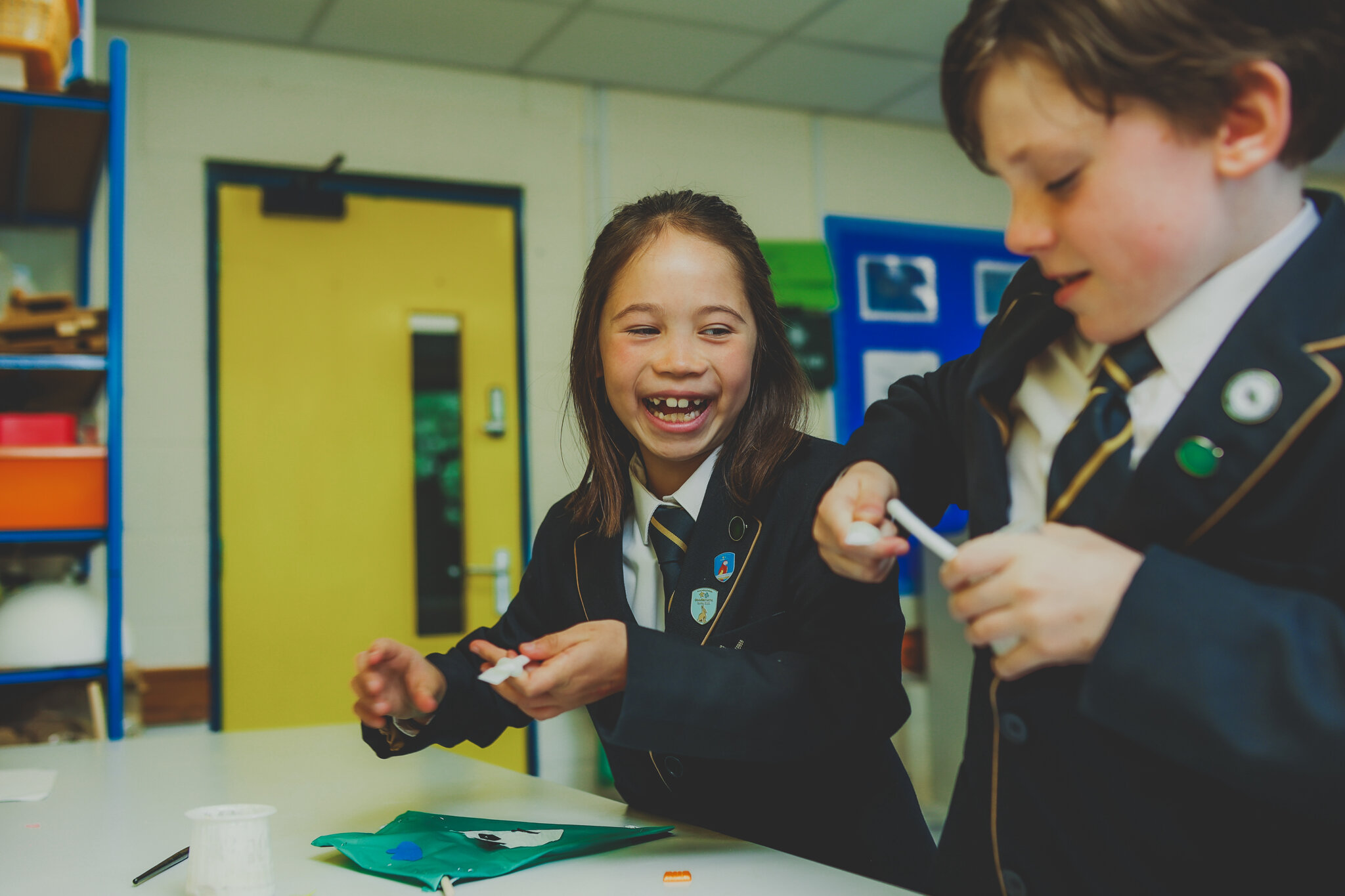 Two Junior School pupils smiling in the garden