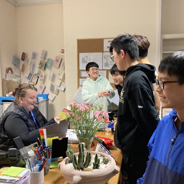 Member of staff talking with pupils